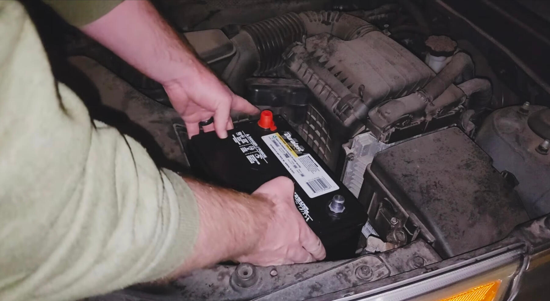 Mobile mechanic installing a new car battery during battery replacement service in Fort Worth Texas